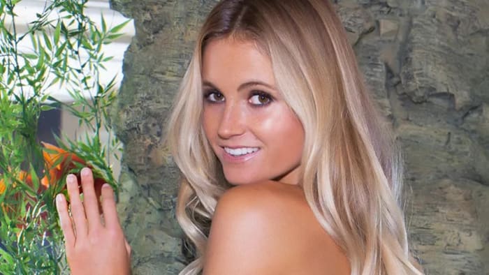 Alana Blanchard smiles over her shoulder at the camera.